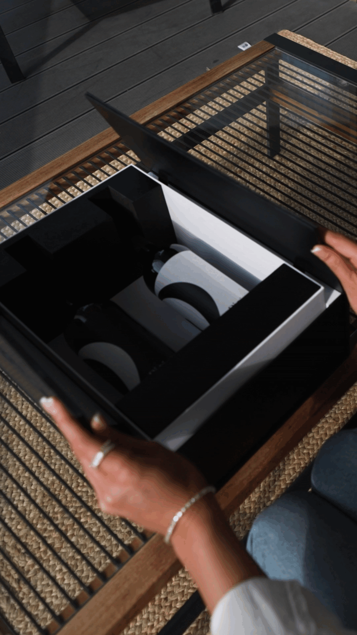 Close up video looking down on a woman’s hands opening the doors of a “Di-vine” elevator gift box and seeing a bottle of “Di-vine” red and a bottle if “Di-vine” white inside.